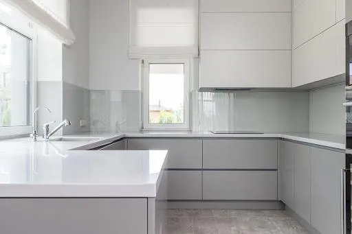 G-shaped modular kitchen with minimal white interior cabinets
